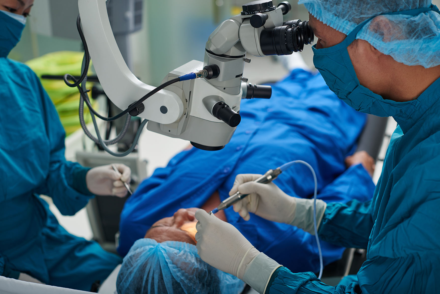 Doctor performing eye surgery in modern clinic